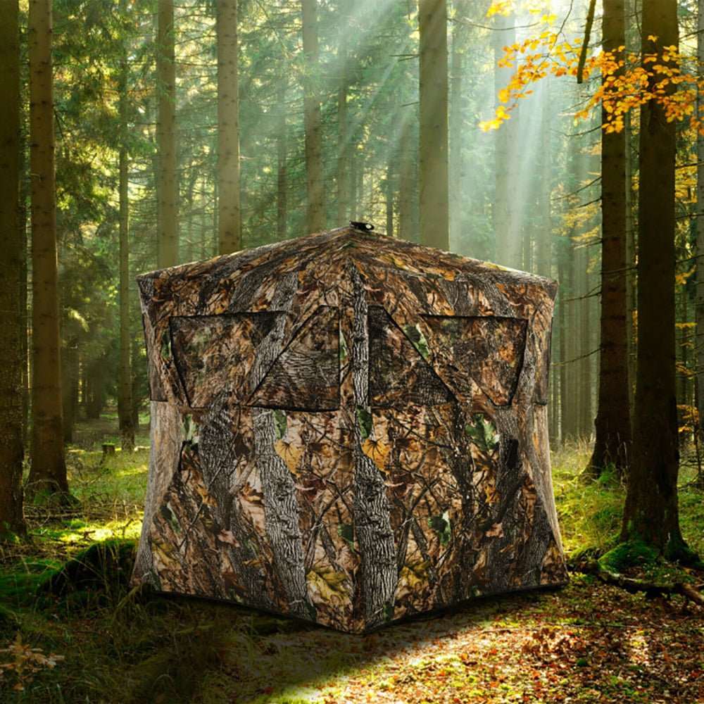 Portable pop up ground hunting blind with jungle camouflage, mesh windows, and compact storage bag for easy transport and stealth setup.
