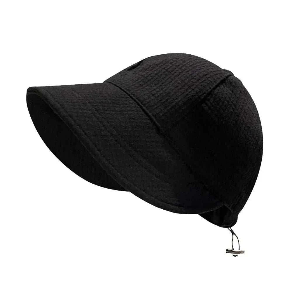 Women foldable sun hat in beige cotton knit providing UV protection, lightweight and packable for outdoor beach and casual wear