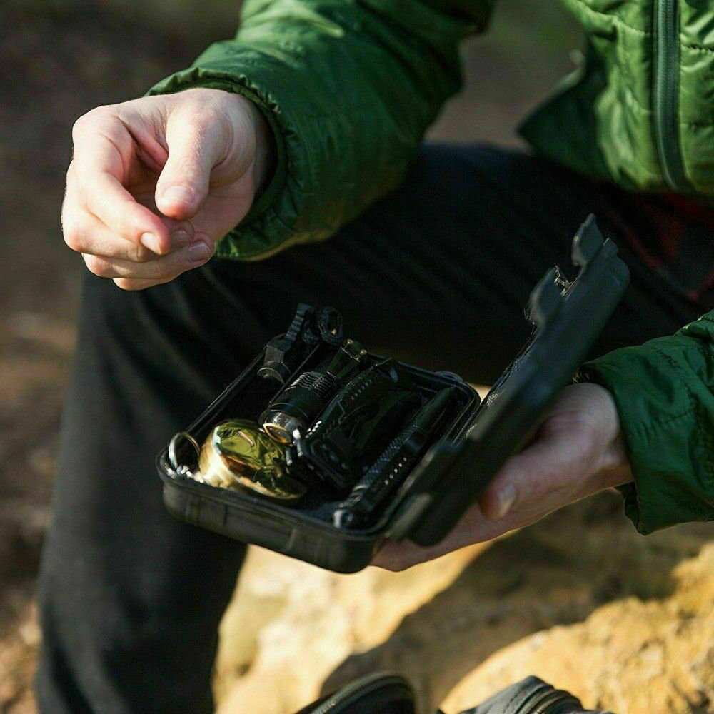 Compact 14 in 1 Outdoor Emergency Survival Kit with compass, whistle, knife, fire starter, and thermal blanket in waterproof case for camping and hiking