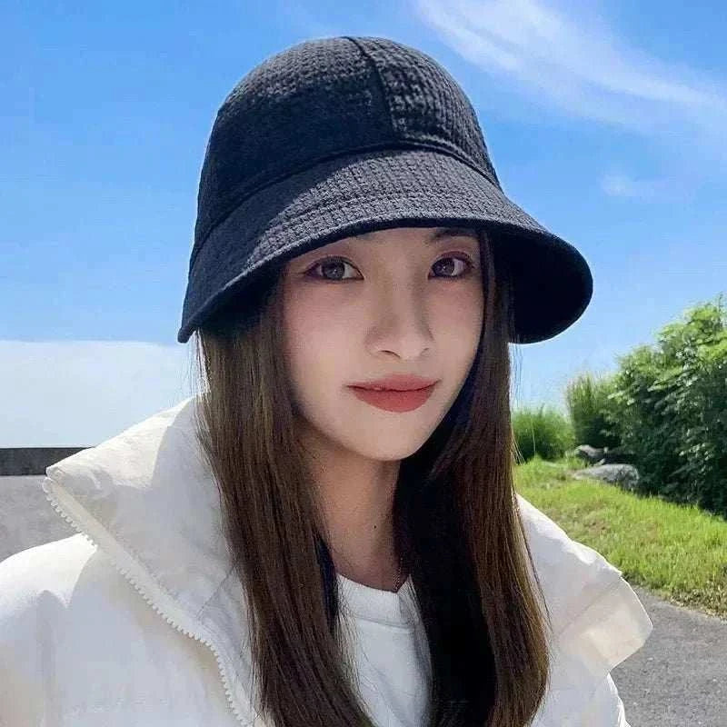 Women foldable sun hat in black providing UV protection, breathable cotton knit, foldable design for beach and outdoor use