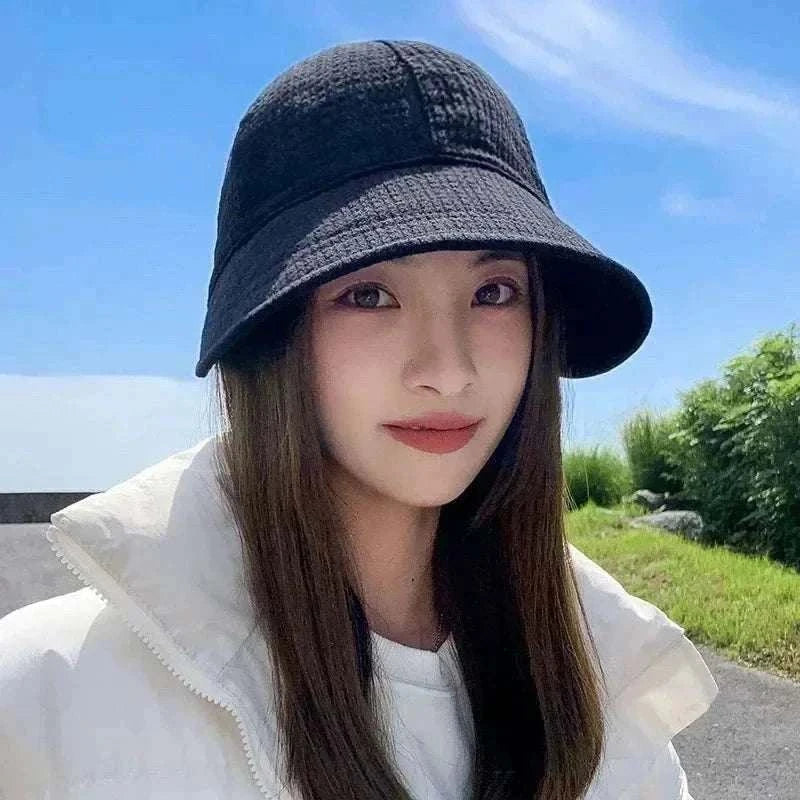Women wearing foldable sun hat with wide brim for UV protection during outdoor hiking