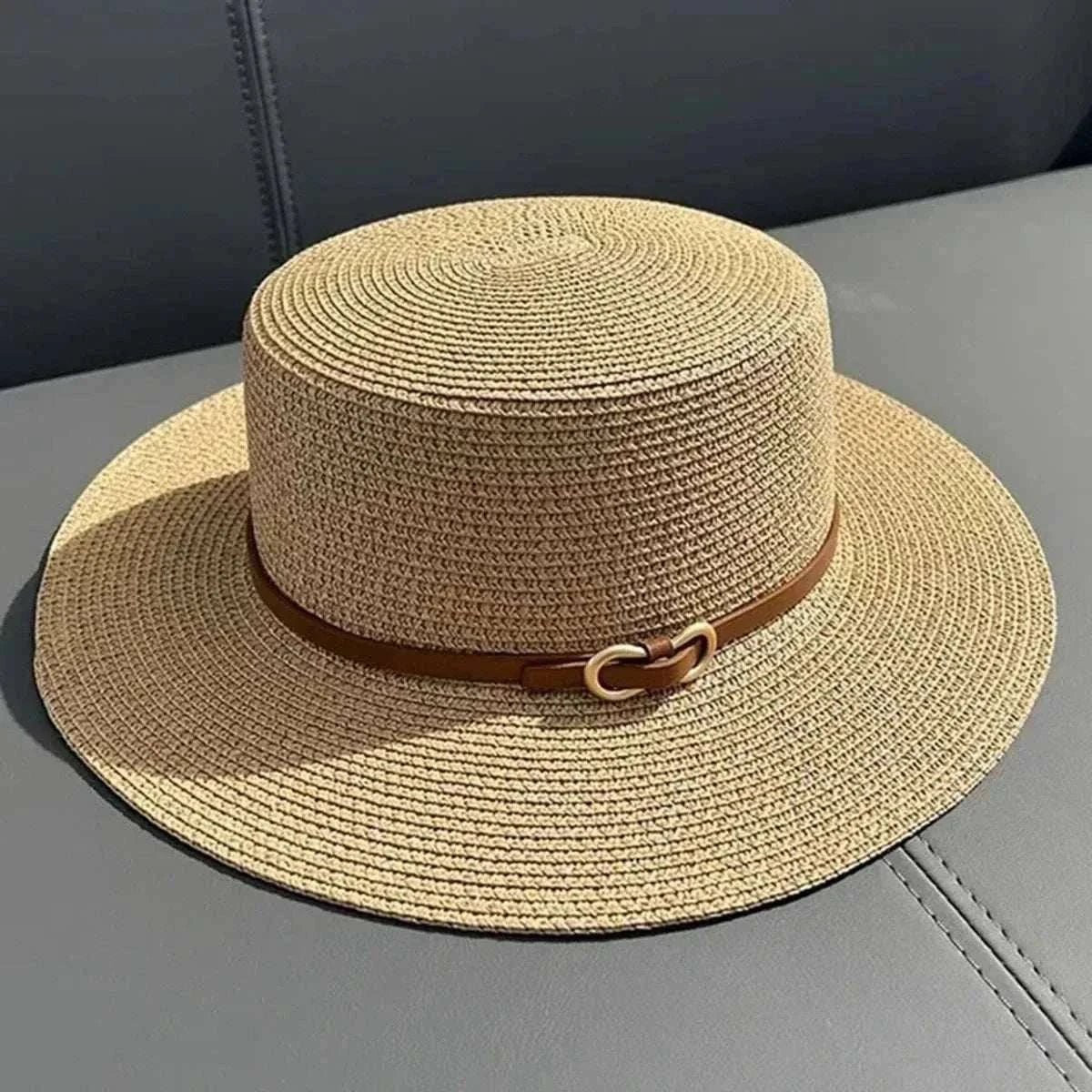 Women wearing a straw Panama sun hat with a bowknot and flat brim at the beach