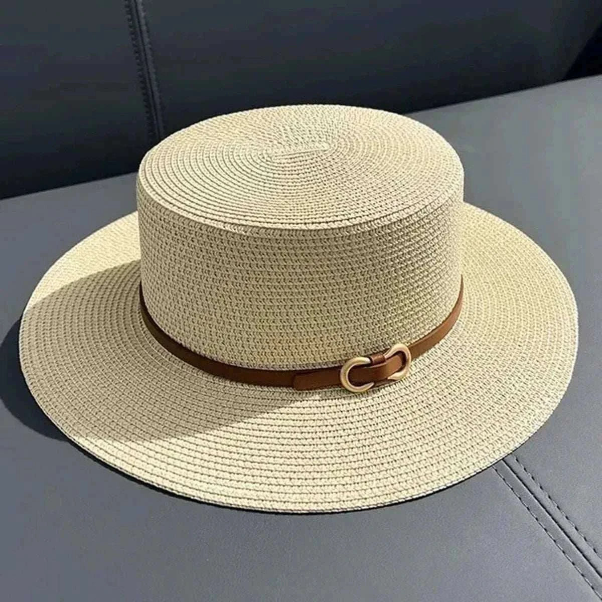 Women wearing a straw Panama sun hat with bowknot and flat brim on the beach