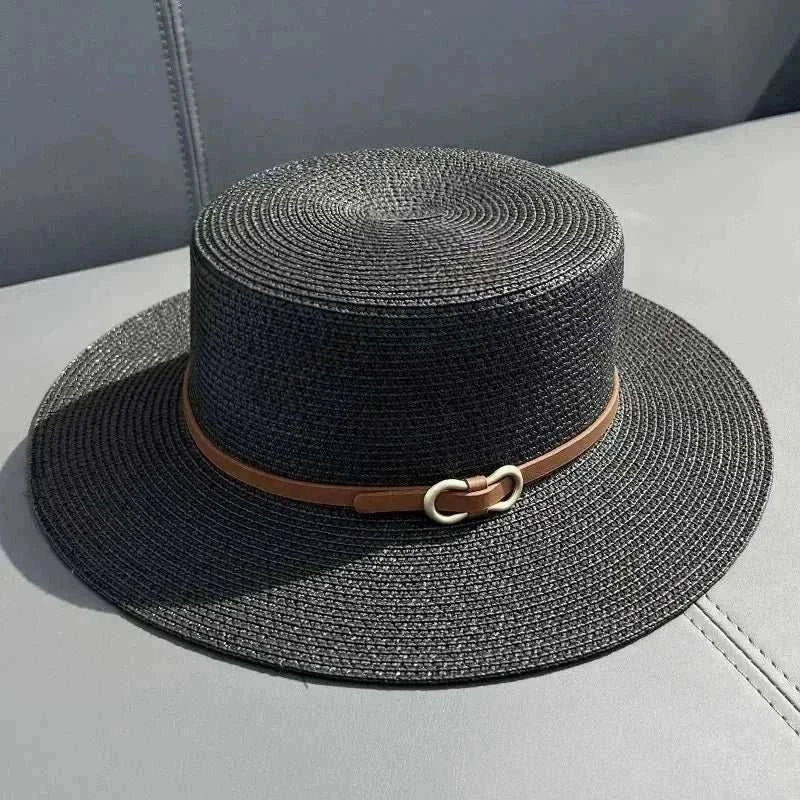 Women wearing straw Panama sun hat with bowknot and flat brim on the beach